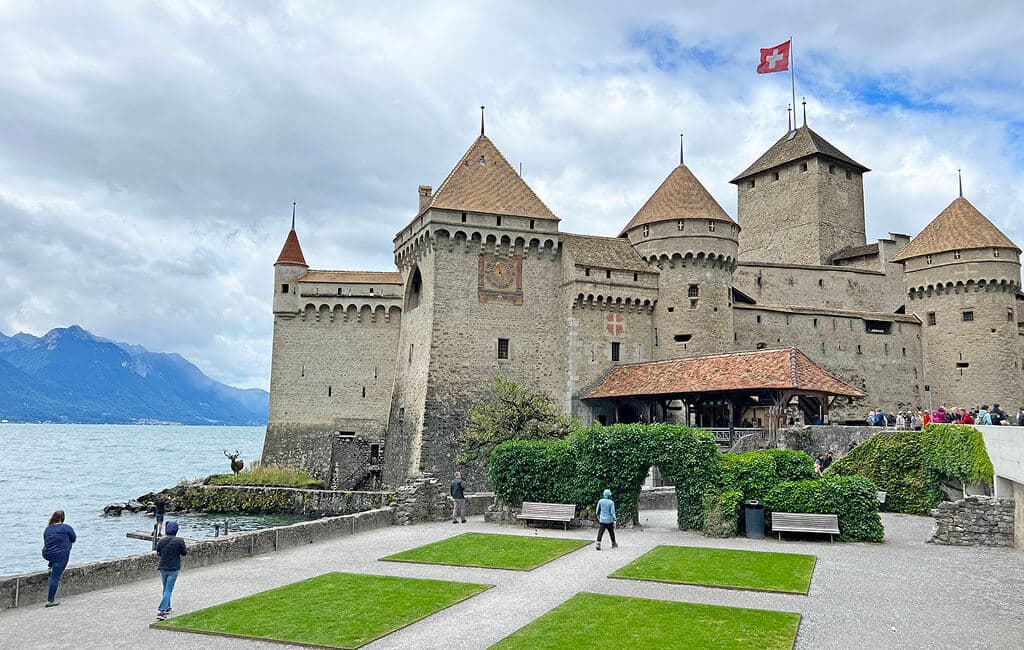 Chillon Castle viewed from the lake with mountains behind