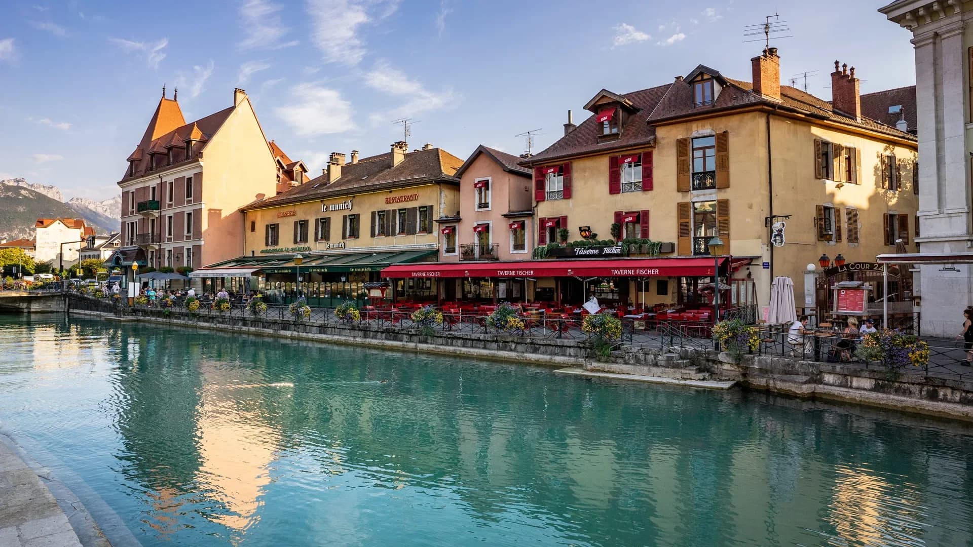 Turquoise waters of Lake Annecy with mountains behind