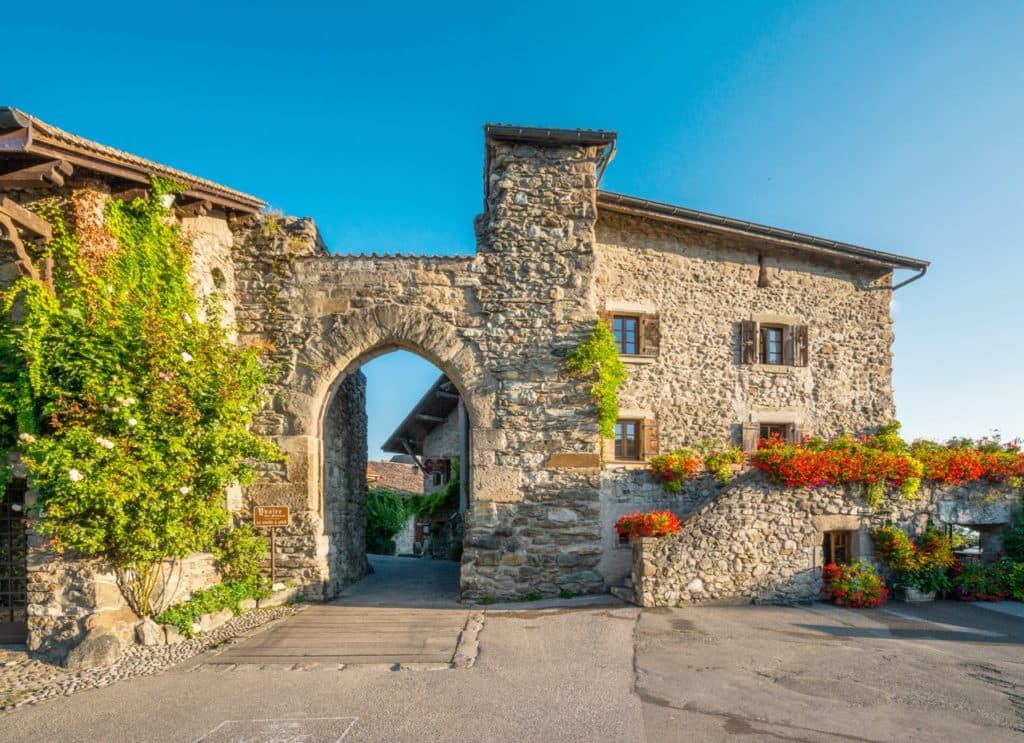 Flower-lined stone facades along a street in Yvoire, France