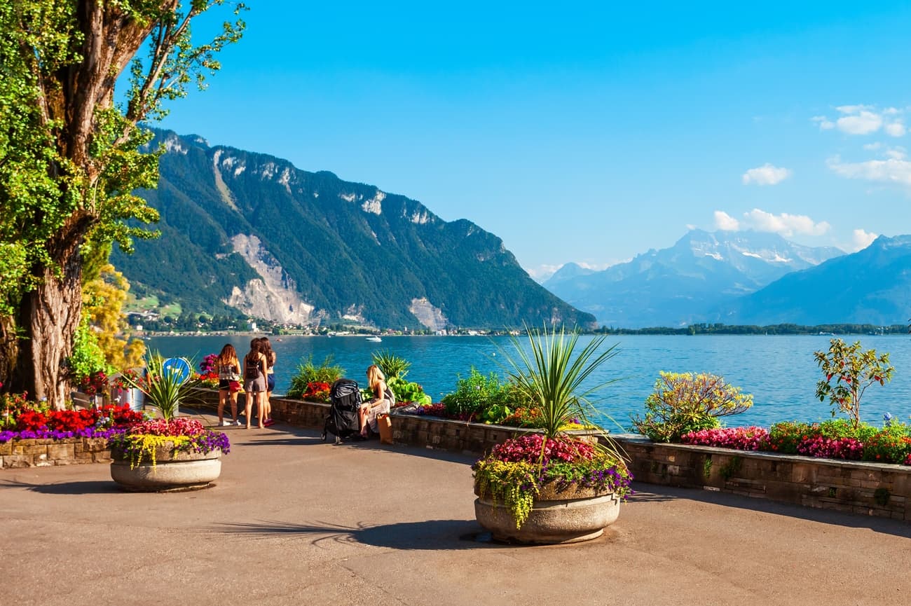 Lakeside promenade in Montreux with flowers and mountain backdrop